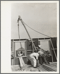 Southeast Missouri Farms Project. House erection. Placing gin pole to erect the gable end