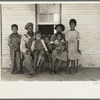 Family of FSA (Farm Security Administration) client, former sharecropper, on porch of old shack home. New Madrid County, Missouri