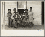 Family of FSA (Farm Security Administration) client, former sharecropper, on porch of old shack home. New Madrid County, Missouri