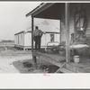 FSA (Farm Security Administration) client and family, former sharecroppers, looking at new home from porch of old shack, Southeast Missouri Farms