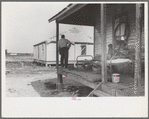 FSA (Farm Security Administration) client and family, former sharecroppers, looking at new home from porch of old shack, Southeast Missouri Farms