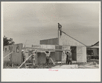 Barn erection. Gable end panels are placed one-half at a time due to weight and length. Southeast Missouri Farms Project