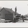 Food storage. Stripping prefabricated forms from wall. Southeast Missouri Farms Project