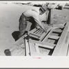 Setting louver in gable and frame, house plant, Southeast Missouri Farms Project yard