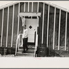 Man leaving infirmary in resettlement camp on land use project near Black River Falls, Wisconsin