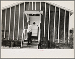 Man leaving infirmary in resettlement camp on land use project near Black River Falls, Wisconsin