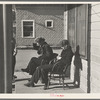 Lumberjacks sitting in front of the Durman Hotel, Little Fork [i.e. Littlefork], Minnesota
