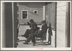 Lumberjacks sitting in front of the Durman Hotel, Little Fork [i.e. Littlefork], Minnesota
