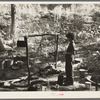 Indian boy and cooking arrangement, blueberry camp near Little Fork [i.e. Littlefork], Minnesota