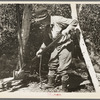 William Besson removing the iron pipe drill from casing near Winton, Minnesota