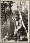 William Besson shaking his iron drill to dislodge particles of structure from the bottom of it near Winton, Minnesota