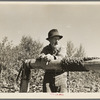 William Besson resting on the windlass of his mine shaft, near Winton, Minnesota