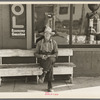 Man sitting in front of store, Craigville, Minnesota