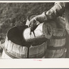 Filling barrels with spring water to be used on his farmstead, Herman Gerling. Wheelock, North Dakota
