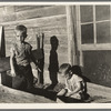 Sons of Floyd Peaches playing around their home near Williston, North Dakota