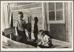 Sons of Floyd Peaches playing around their home near Williston, North Dakota
