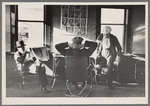 Lumberjacks in hotel lobby at Durman Hotel, Little Fork [i.e. Littlefork], Minnesota. Many of the men that rise early spend a few hours here reading and talking before going to work