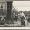 Daughter of cut-over farmer carrying water near Northome, Minnesota