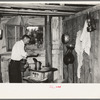 Squatter makes coffee in kitchen at his home in abandoned warehouse, Caruthersville, Missouri