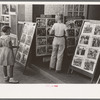 Children looking at posters in front of movie, Saturday, Steele, Missouri