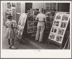 Children looking at posters in front of movie, Saturday, Steele, Missouri