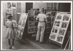 Children looking at posters in front of movie, Saturday, Steele, Missouri