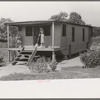 House on river side of levee near Caruthersville, Missouri. Note this is adaptation of house boat