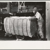 Removing bales of cotton from gin press, Lehi, Arkansas
