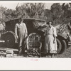 Migrant cane chair maker and wife in front of their automobile home, near Paradis, Louisiana