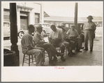 Group of Italians talking, Decatur Street, New Orleans, Louisiana