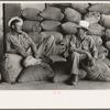 Farmers sitting on bags of rice, state mill, Abbeville, Louisiana