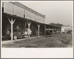 Unloading platform of state mill, Abbeville, Louisiana, with farmers' trucks waiting to be unloaded