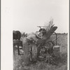 Member of Lake Dick Cooperative Association repairing mowing machine, Arkansas