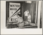 Decorating store window for National Rice Festival, Crowley, Louisiana