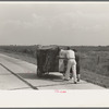 Traveling evangelists pushing cart on road between Lafayette and Scott, Louisiana