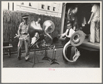 Members of Southwestern University band unloading instruments from truck, National Rice Festival, Crowley, Louisiana