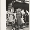 People standing on sidewalk watching parade, National Rice Festival, Crowley, Louisiana