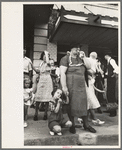 People standing on sidewalk watching parade, National Rice Festival, Crowley, Louisiana