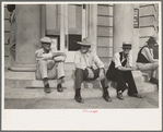 Men sitting on bank steps during National Rice Festival, Crowley, Louisiana