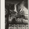 Wife of traveling photographer tinting small portraits, National Rice Festival, Crowley, Louisiana