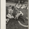 People resting on grass plot in middle of street, National Rice Festival, Crowley, Louisiana
