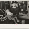 Woman with child in front of store during National Rice Festival, Crowley, Louisiana