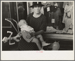Woman with child in front of store during National Rice Festival, Crowley, Louisiana