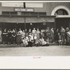 People lined up along sidewalk during parade, National Rice Festival, Crowley, Louisiana
