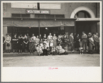 People lined up along sidewalk during parade, National Rice Festival, Crowley, Louisiana
