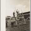 Setting up stand for mechanical amusement device, state fair, Donaldsonville, Louisiana