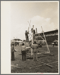 Setting up stand for mechanical amusement device, state fair, Donaldsonville, Louisiana