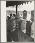 Man looking through penny peep show, state fair, Donaldsonville, Louisiana