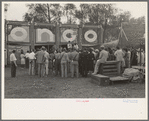 Crowd listening to barker at sideshow, state fair, Donaldsonville, Louisiana