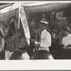 Barker at sideshow with performers, state fair, Donaldsonville, Louisiana